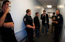 Police crowd into the office of Conservative MP Terence Young's Oakville office before arresting a 'Free Marc' protestor for trespassing. (Photos by Leah Gair)